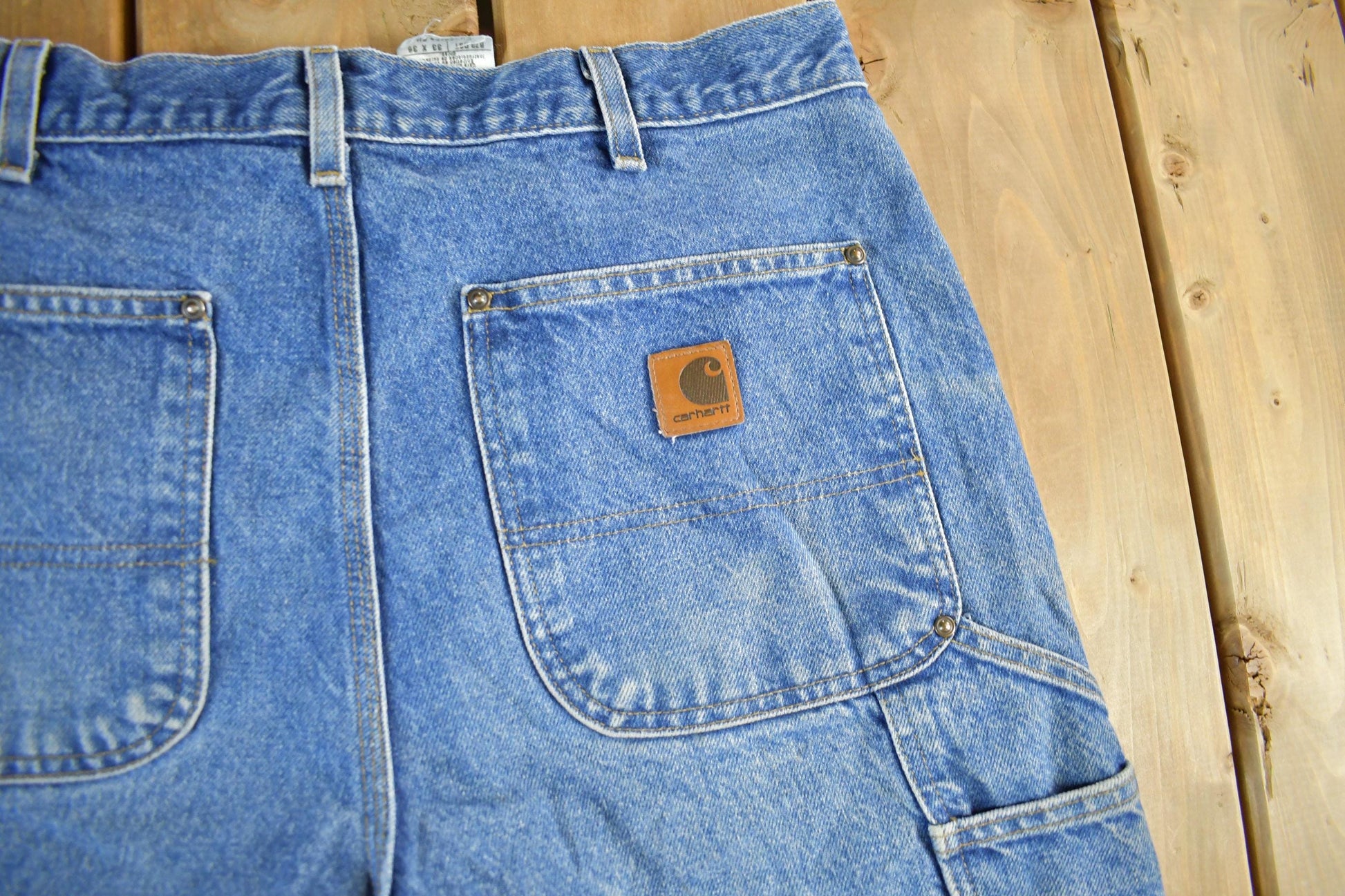 Vintage 2000s Carhartt Distressed Double Knee Denim Work Jeans Men's Medium 33 x 36 from propervintagecanada