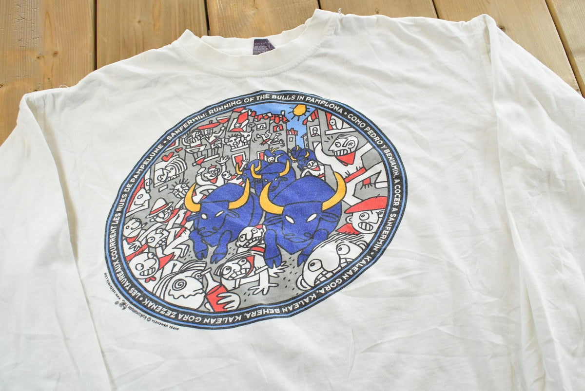 Vintage 2000s Kukuxumusu Running of the Bulls Pamplona Spain Long Sleeve Souvenir T-Shirt Men's M from propervintagecanada