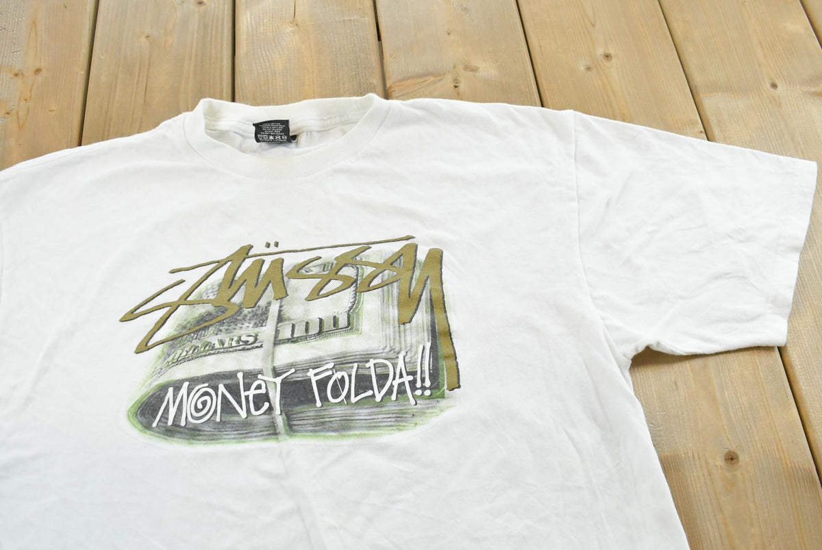 Vintage 2000s Stussy Money Folda!! Graphic Print T-Shirt Men's L from propervintagecanada