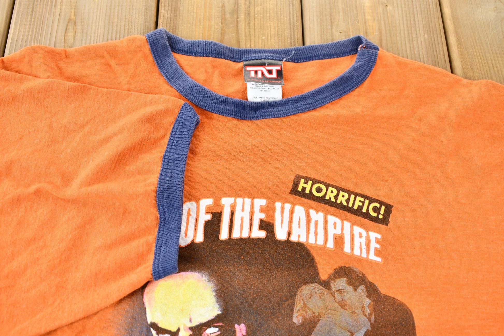 Vintage 2005 Dracula Night of the Vampire Orange and Blue Ringer Graphic T-Shirt Men's Large from propervintagecanada
